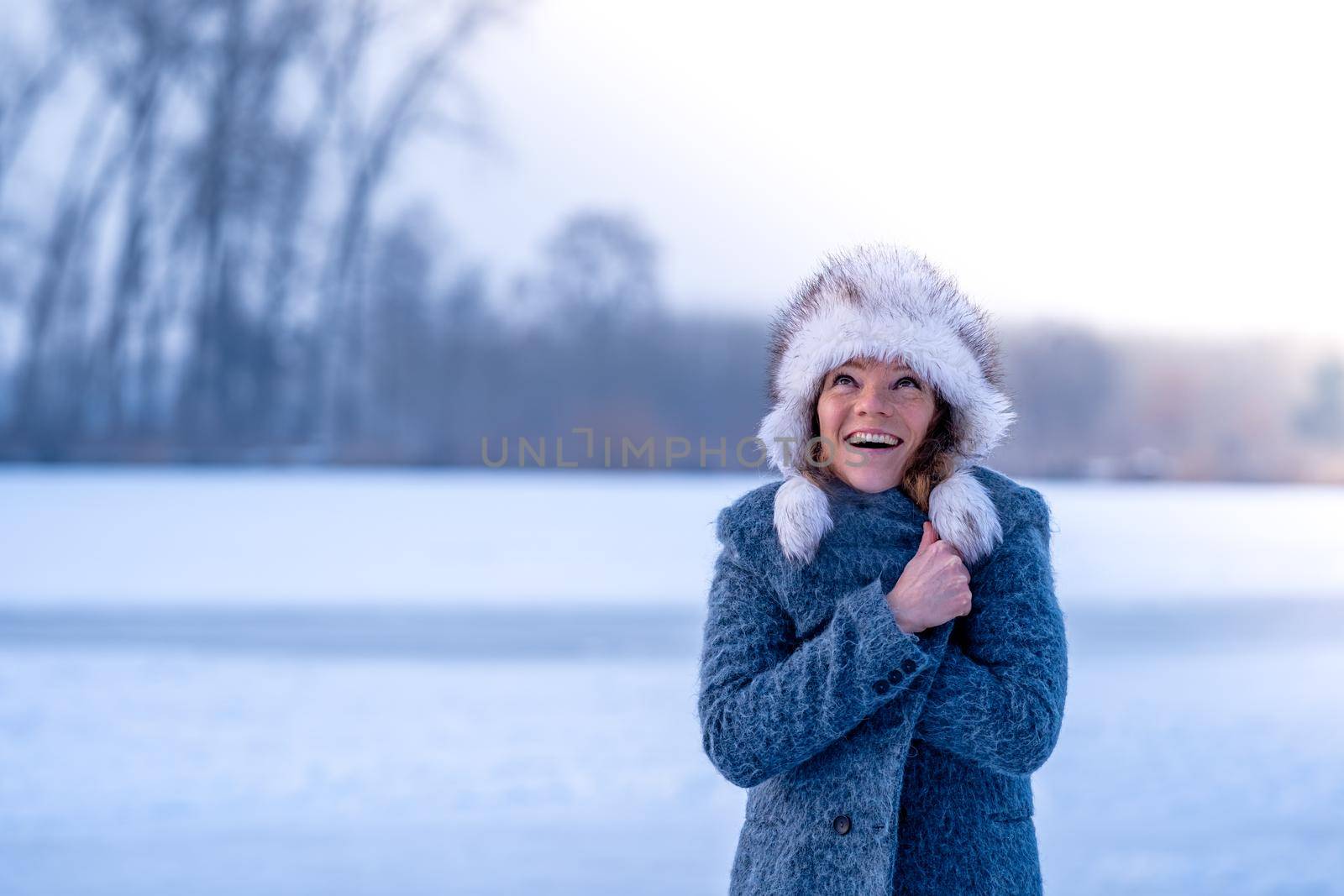 young woman in winter clothes in nature by Edophoto