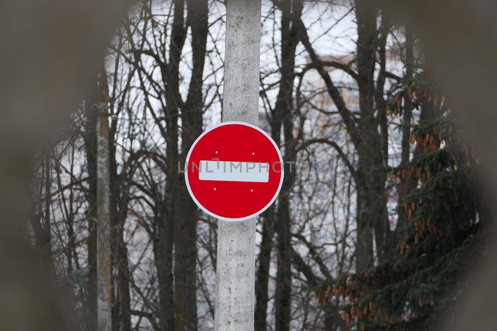 A road sign on a pole. Passage is forbidden, round white on red. by Olga26