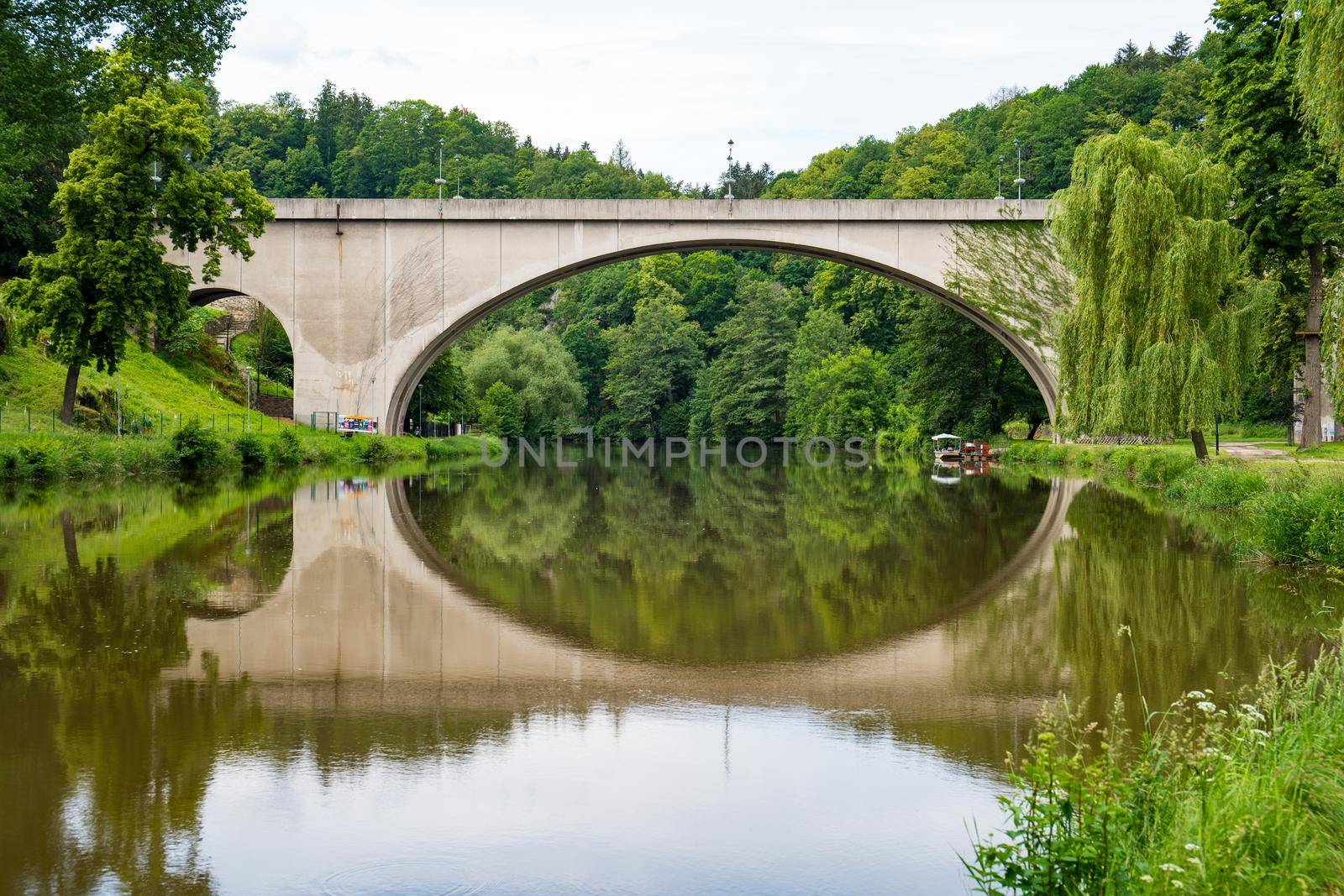 bridge reflecting in the calm river