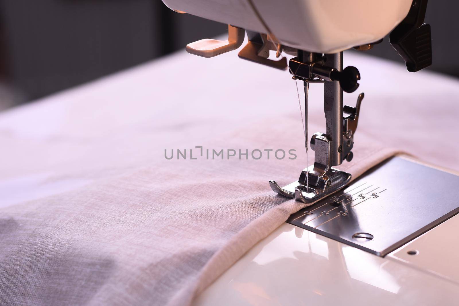 The process of sewing on a sewing machine. No people. No hands. Close-up.