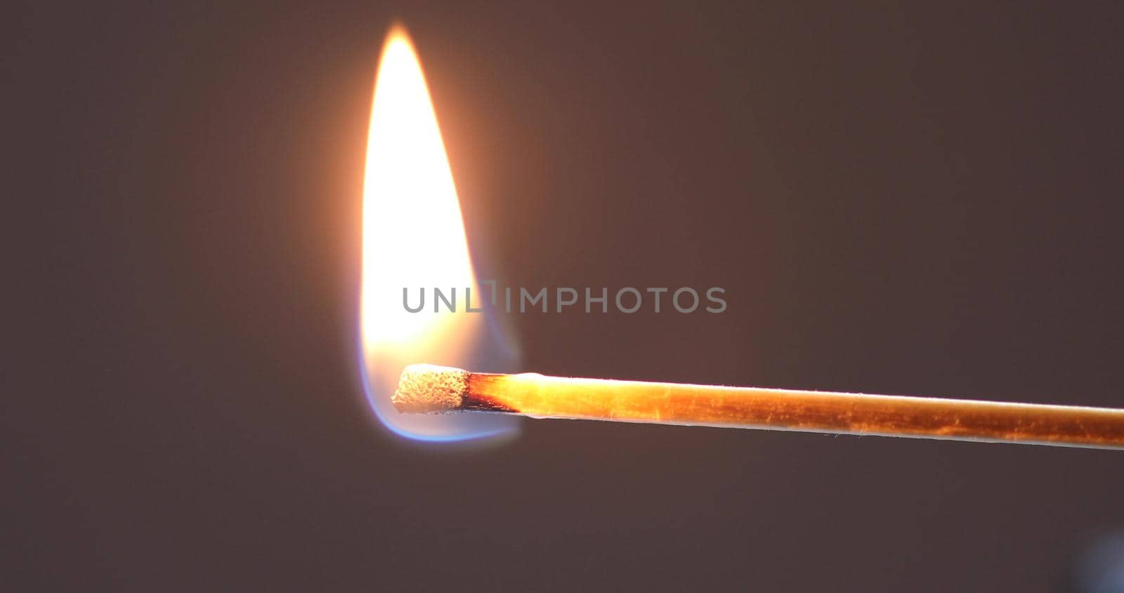 Matchstick burns with a flame and bends upward blackening