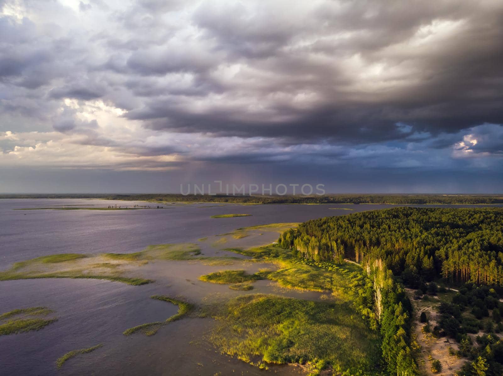 Stromy clouds over eautful peninsula between lakes Snudy and Strusto, National Park Braslau Lakes, Belarus.