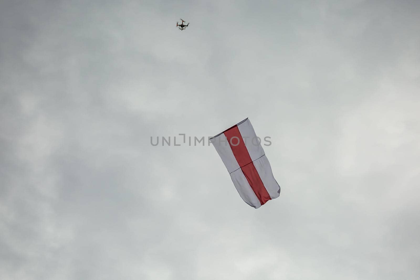 Historic flag of Belarus fly in the sky by the drone.