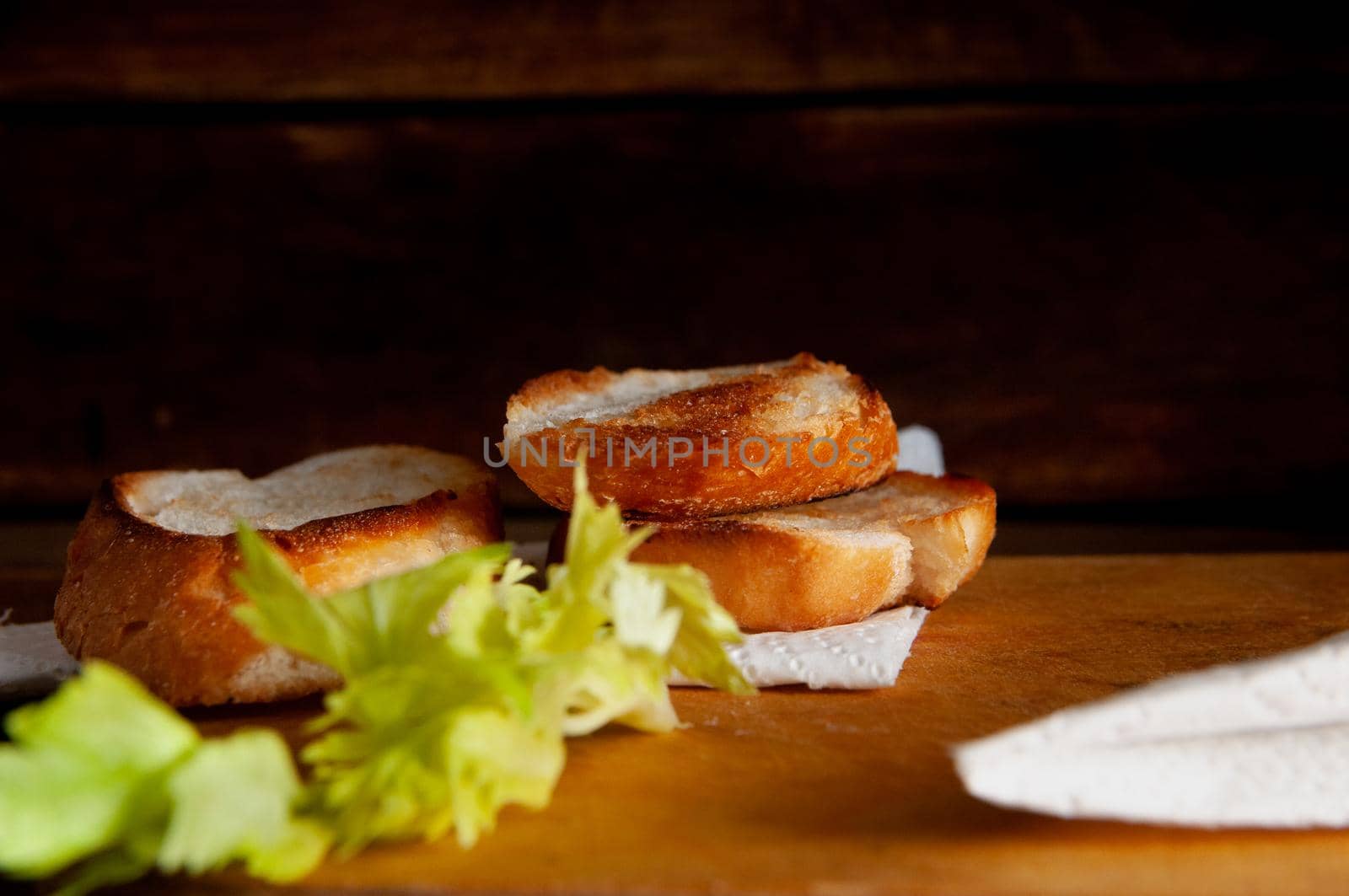 toasted white bread with herbs on a table background.slice toast bread background texture
