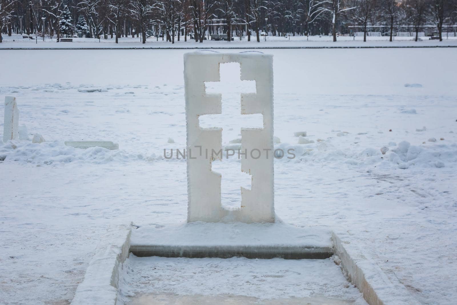 Cross near ice bath. Winter Baptism in Minsk Belarus. Baptismal bathing - a folk tradition that exists in Russia, Belarus, Ukraine. Bathing in the ice hole. Plunge into the ice water.