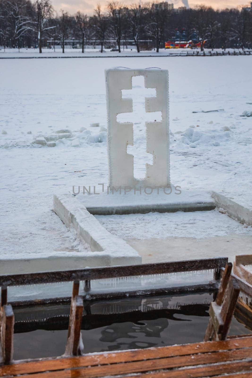 Cross near ice bath. Winter Baptism in Minsk Belarus. Baptismal bathing - a folk tradition that exists in Russia, Belarus, Ukraine. Bathing in the ice hole. Plunge into the ice water.