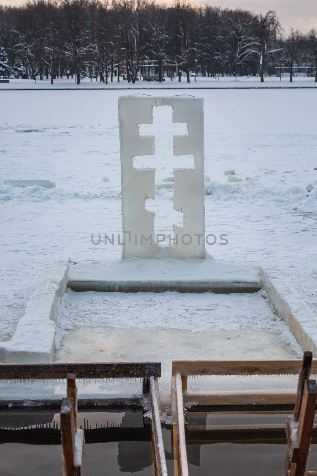 Cross near ice bath. Winter Baptism in Minsk Belarus. Baptismal bathing - a folk tradition that exists in Russia, Belarus, Ukraine. Bathing in the ice hole. Plunge into the ice water.