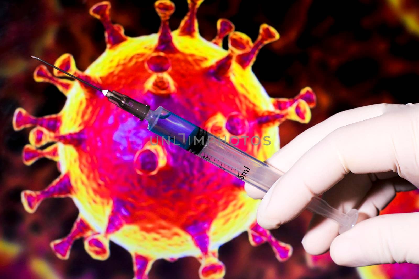 Medical professional hand with surgery glove holding syringe with Covid-19 virus vaccine and covid virus microscopic image in the background