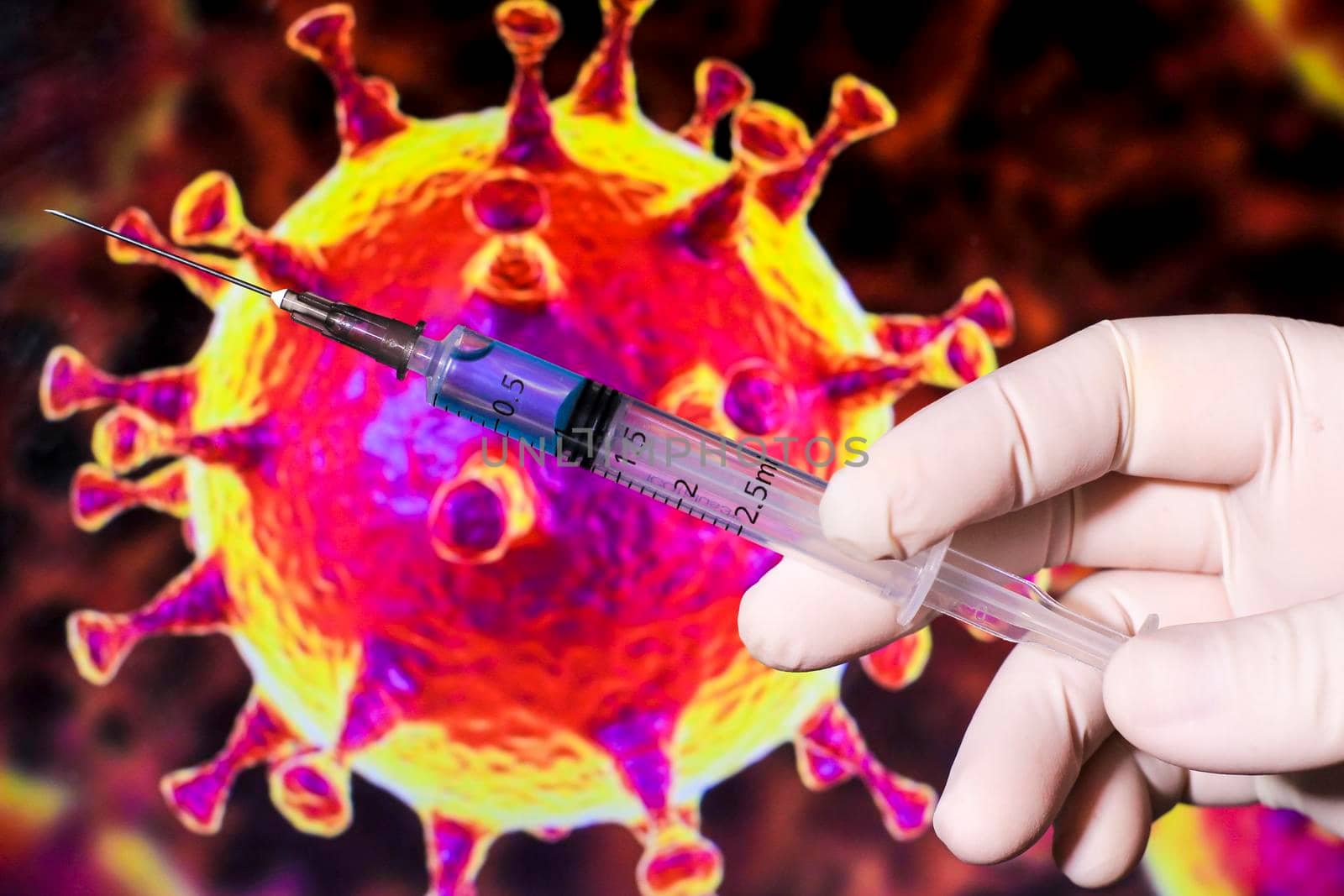 Medical professional hand with surgery glove holding syringe with Covid-19 virus vaccine and covid virus microscopic image in the background