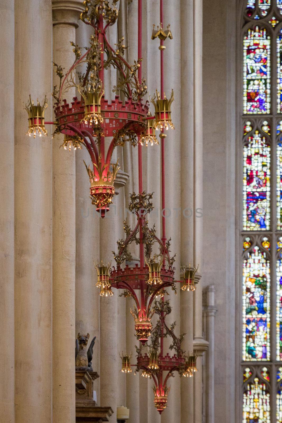 Detail of metal lamps hanging inside Bath Abbey on a sunny day