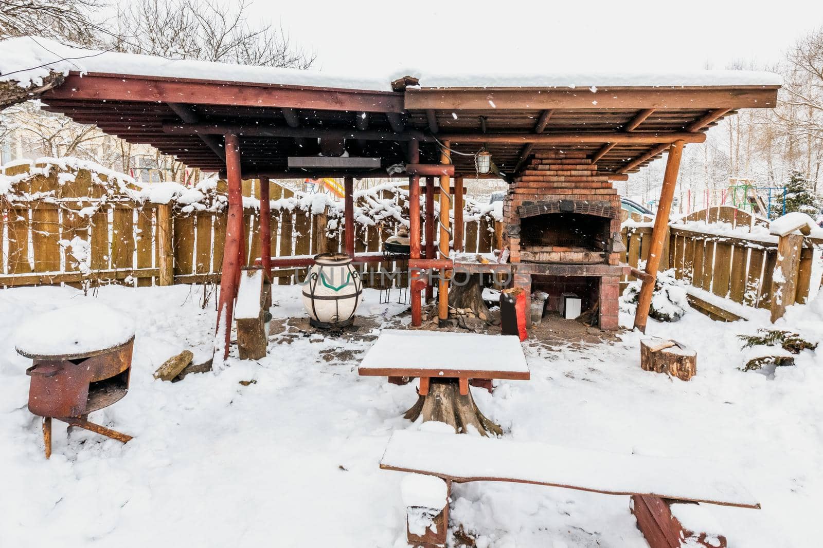 Decorated wooden house with textured wall covered with a heavy snow in the village in Belarus.