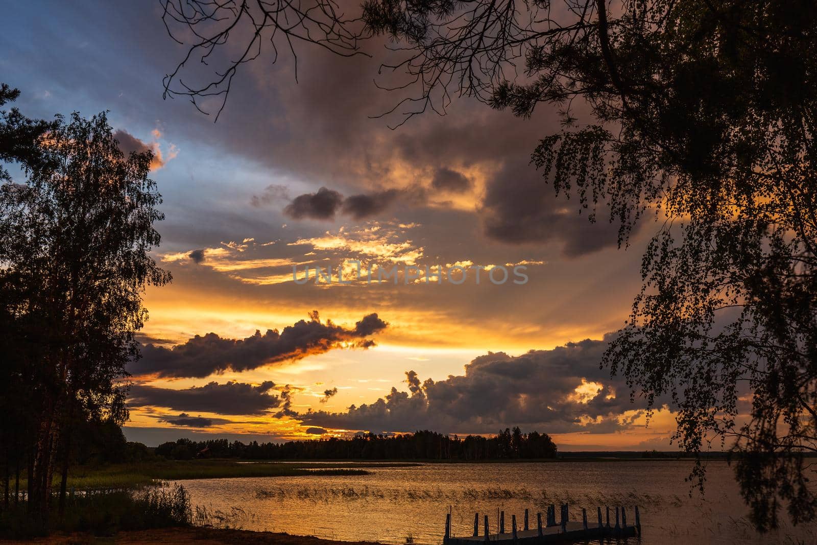 Amazing sunset at the Braslaw lakes with the cloudy sky. Braslaw district, Belarus.