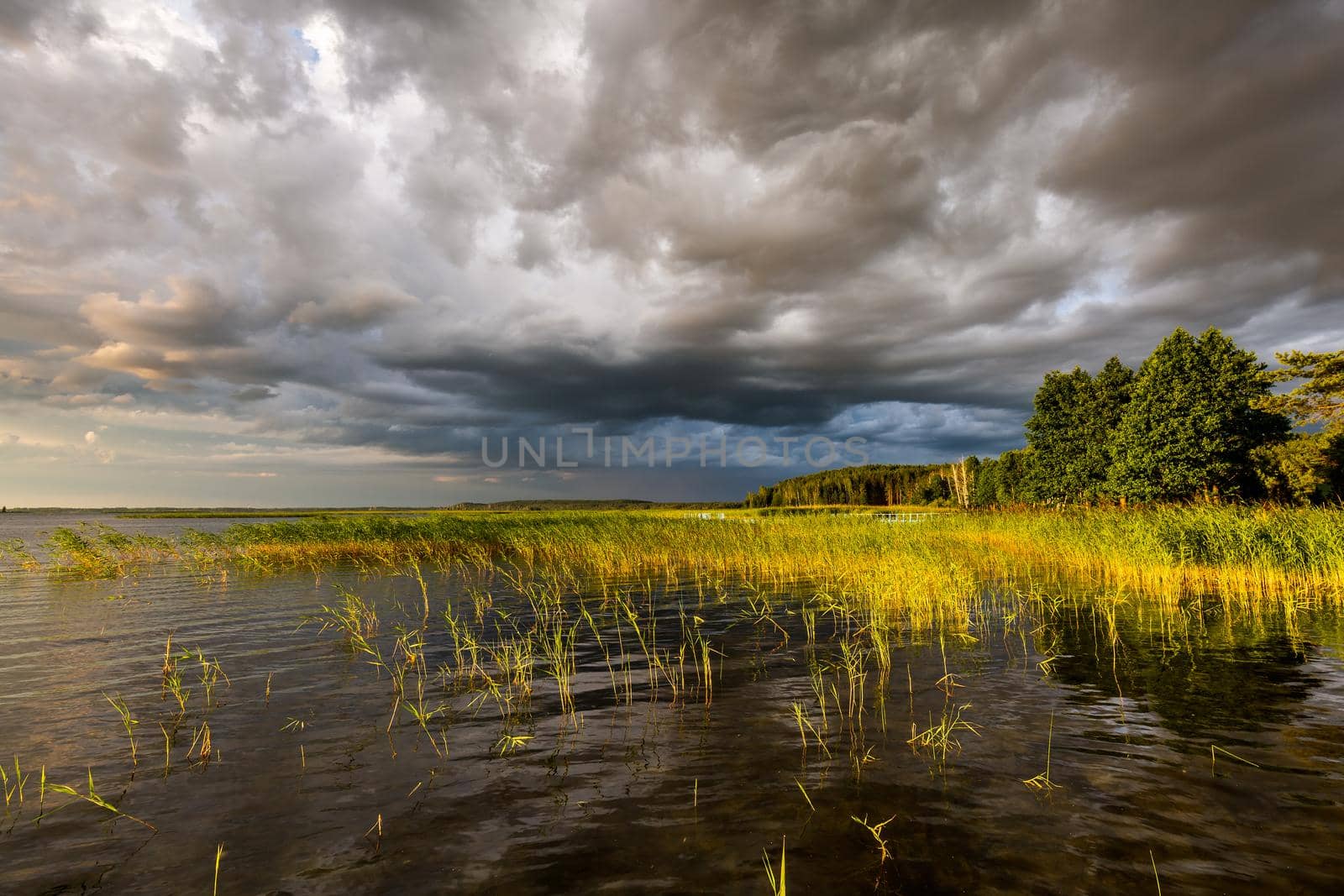Amazing sunset at the Braslaw lakes with the cloudy sky. Braslaw district, Belarus.