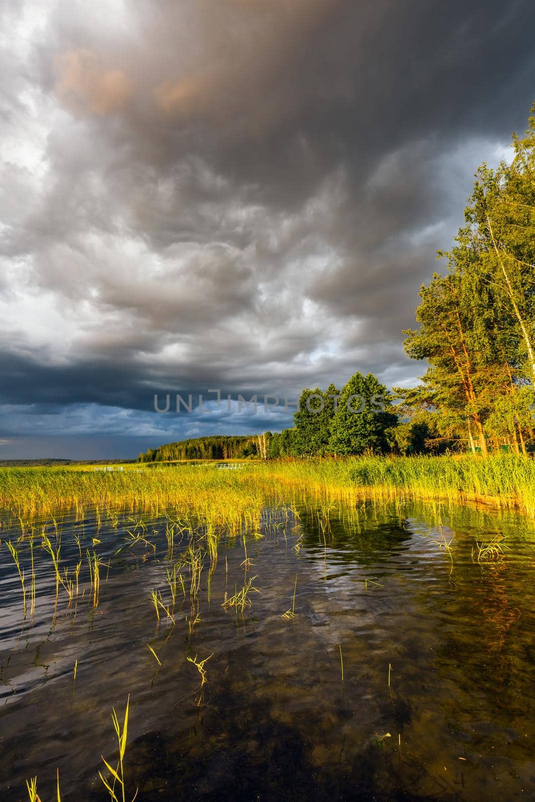Amazing sunset at the Braslaw lakes with the cloudy sky. Braslaw district, Belarus.