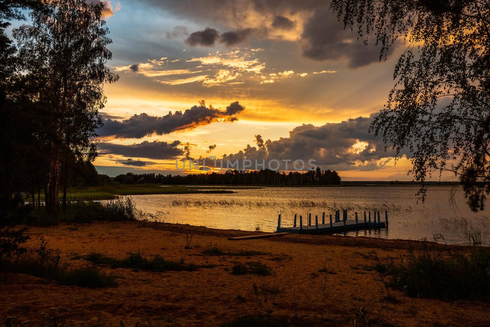 Amazing sunset at the Braslaw lakes with the cloudy sky. Braslaw district, Belarus.