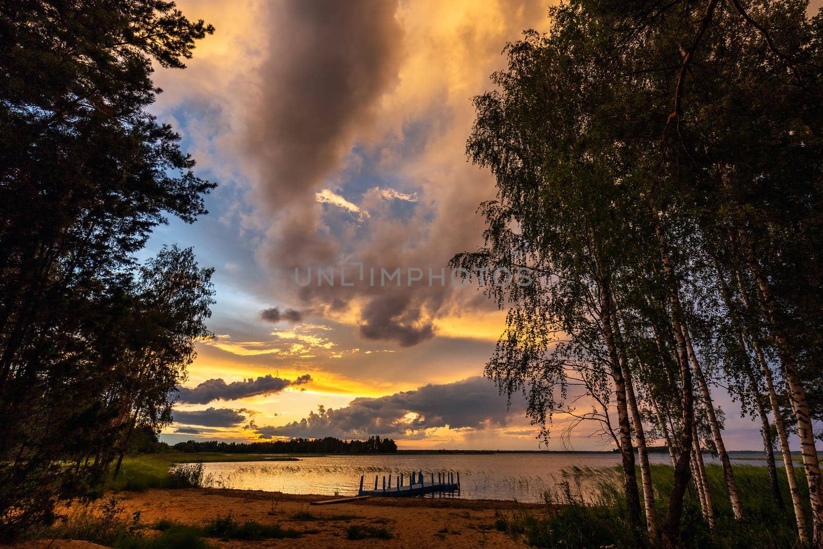 Amazing sunset at the Braslaw lakes with the cloudy sky. Braslaw district, Belarus.