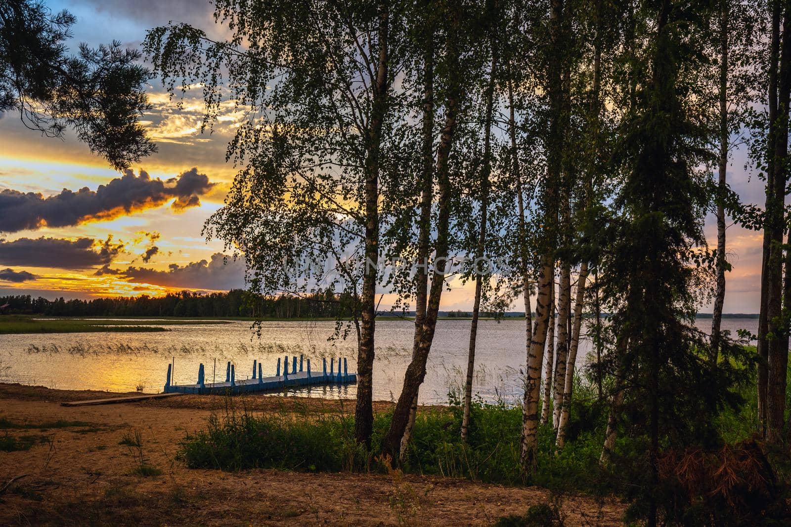 Amazing sunset at the Braslaw lakes with the cloudy sky. Braslaw district, Belarus.