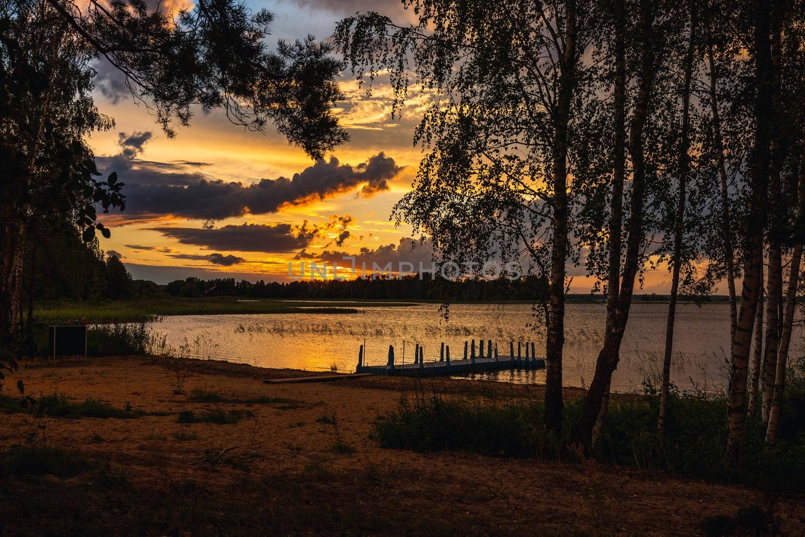 Amazing sunset at the Braslaw lakes with the cloudy sky. Braslaw district, Belarus.