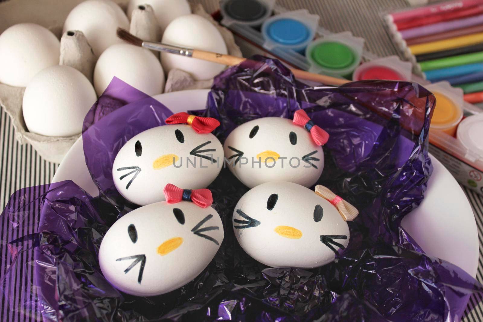 Kitty easter eggs on purple cellophane paper by soniabonet