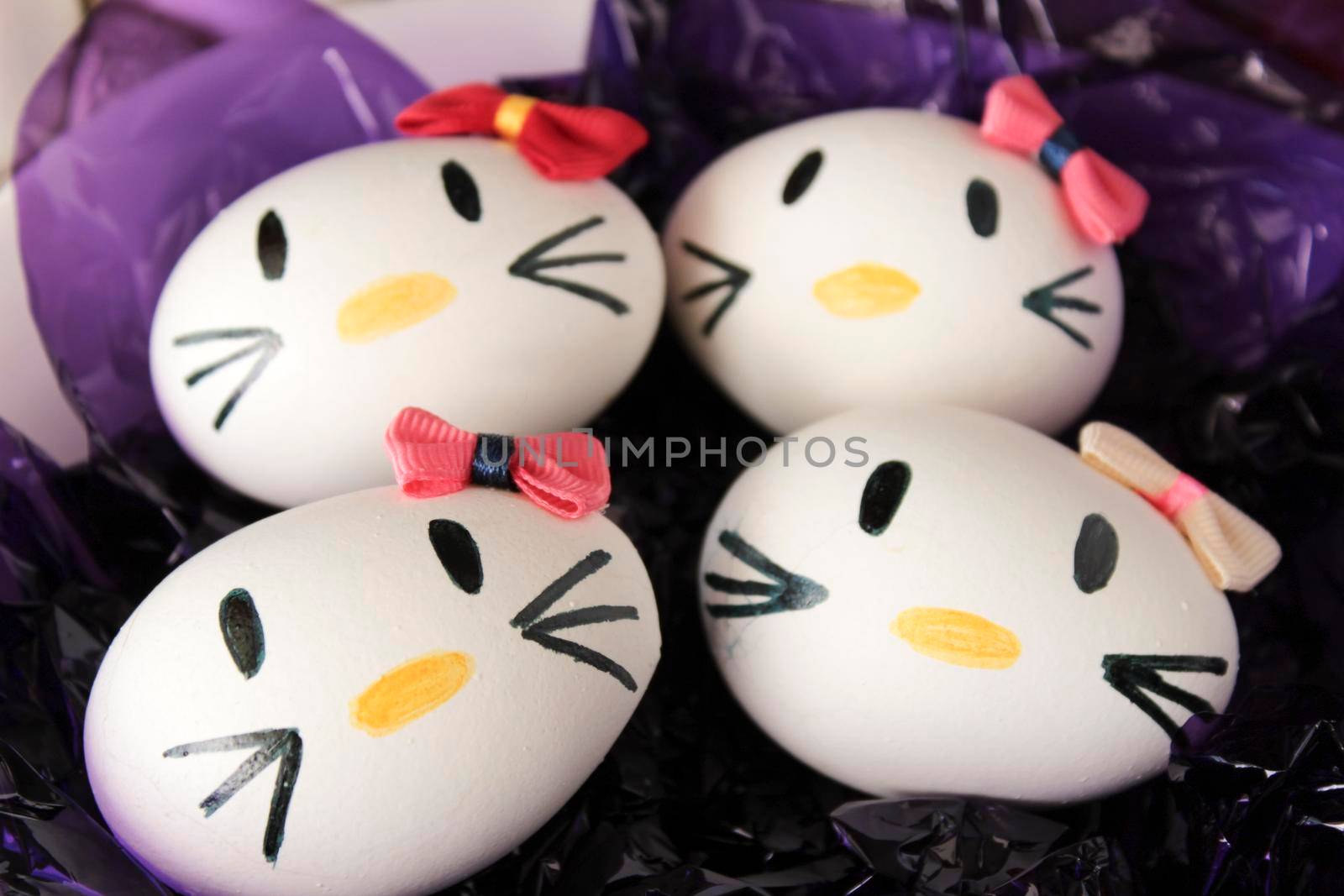 Kitty easter eggs on purple cellophane paper by soniabonet