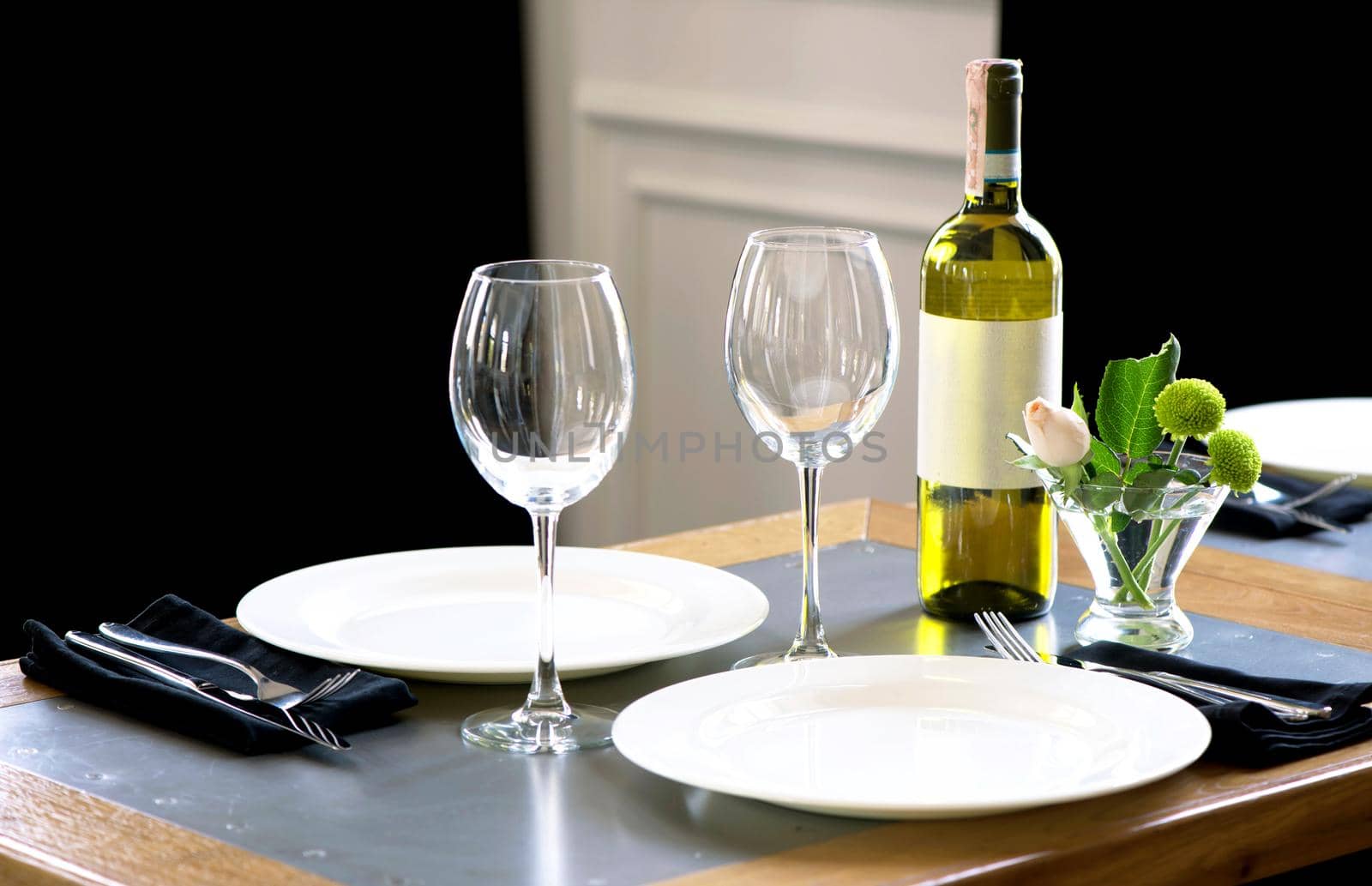 Served table in restaurant, focus on near glass and plate