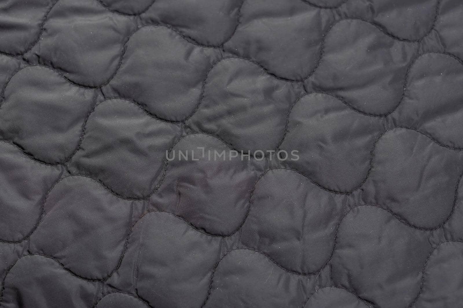 Close-up of a piece of quilted fabric, jacket lining. by galinasharapova