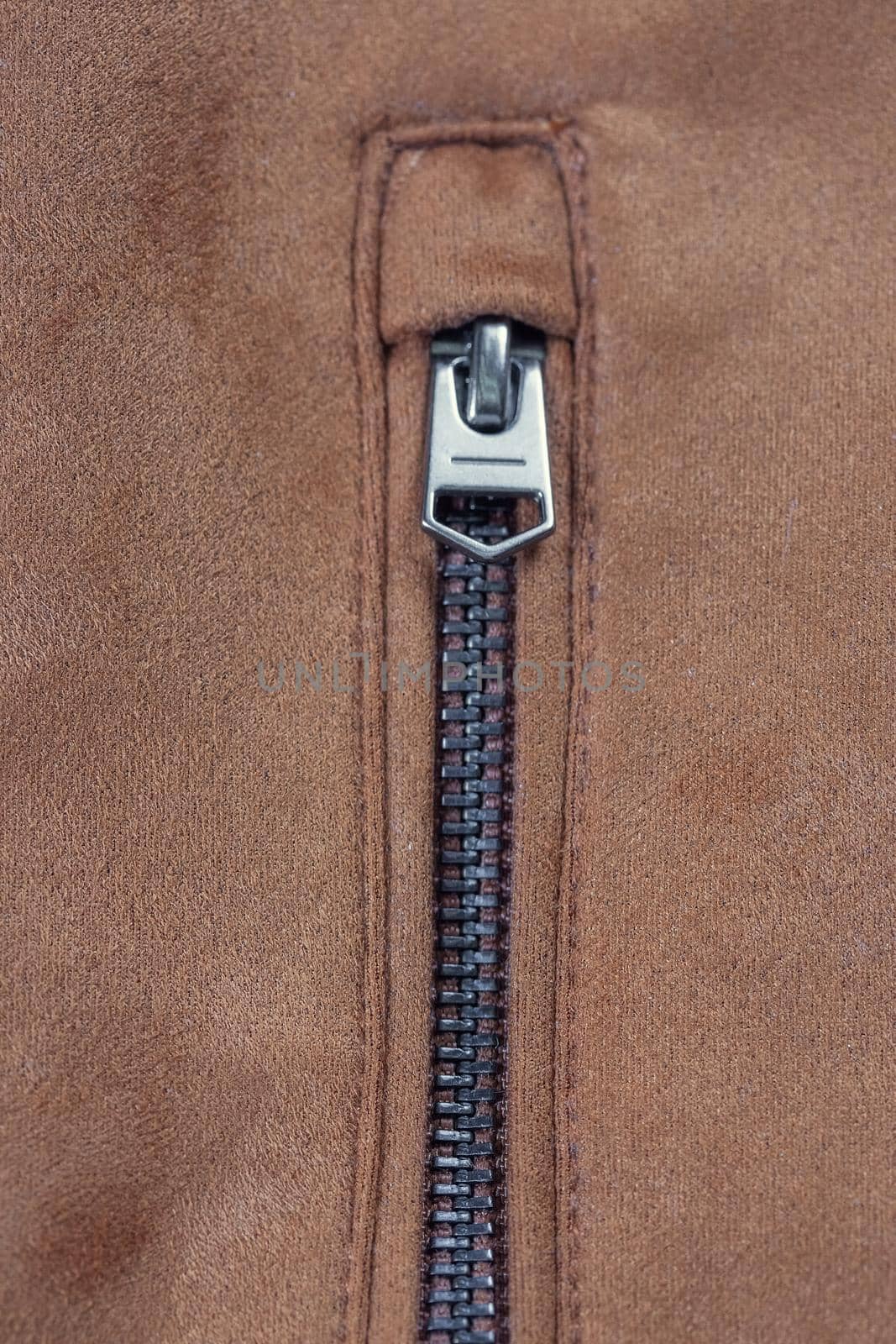 Close-up of a zippered pocket on a faux suede jacket.