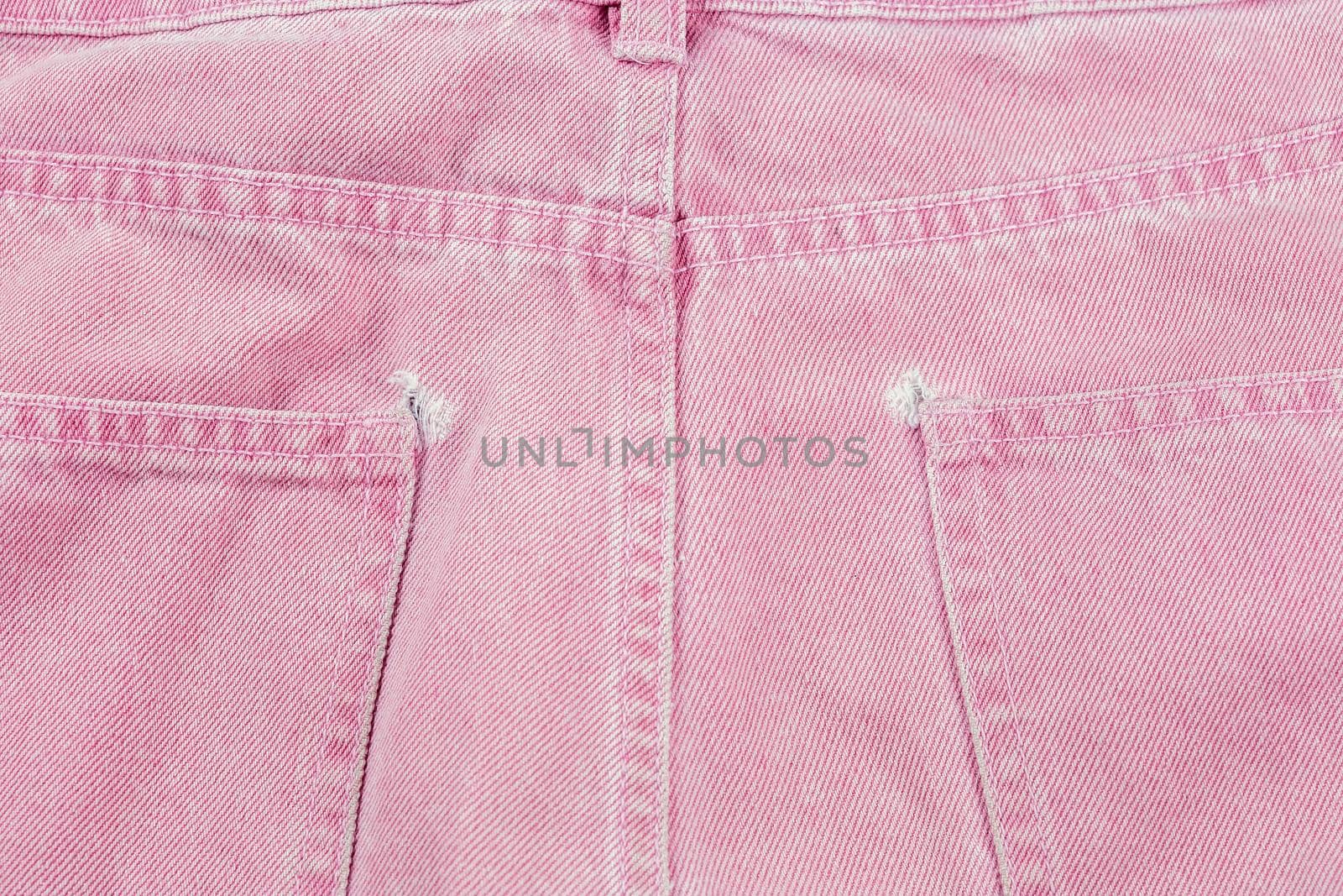 A close-up of a frayed pink jeans pocket, a torn off pocket by galinasharapova