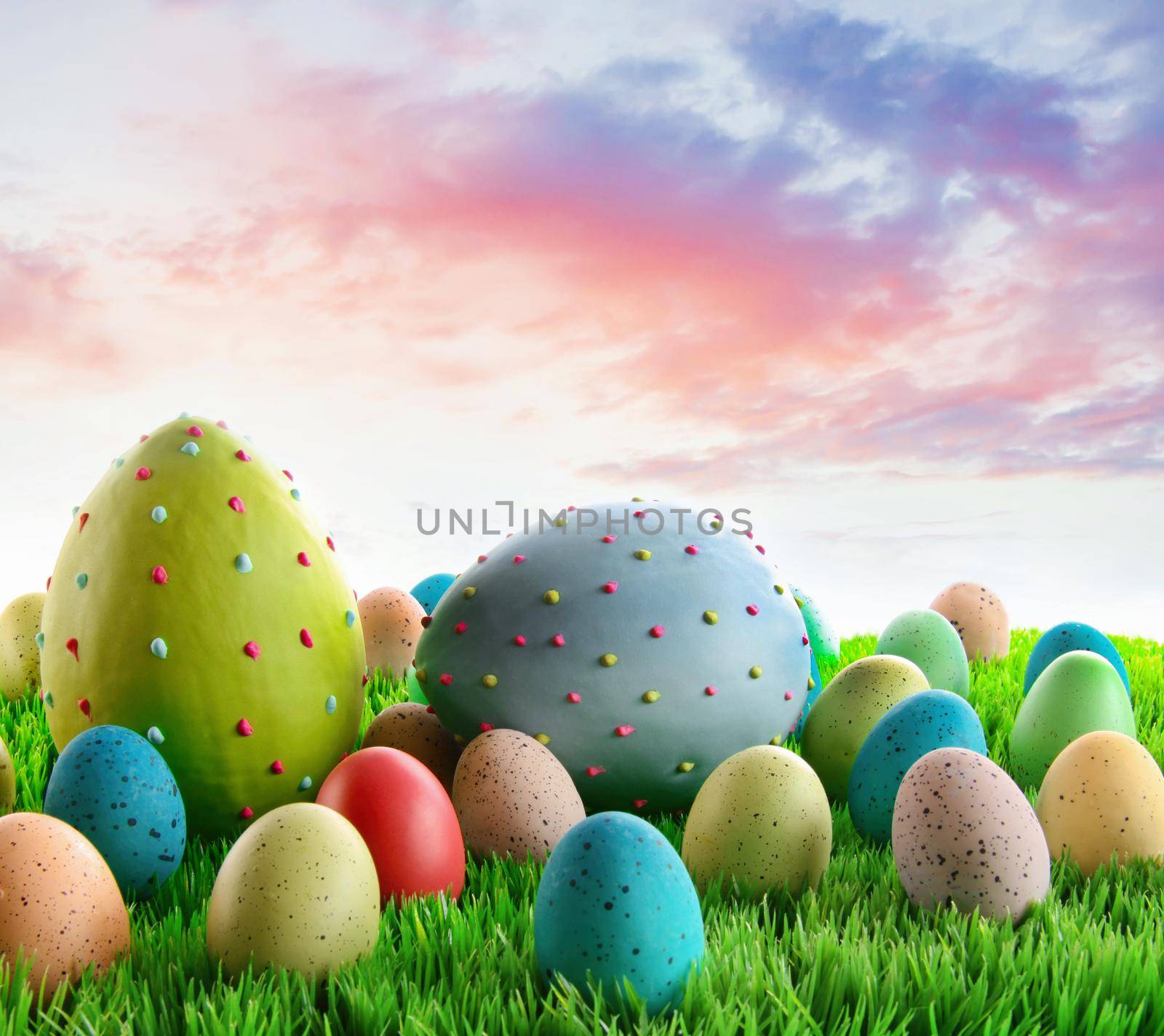 Colorful decorated eggs in the grass with sky in background
