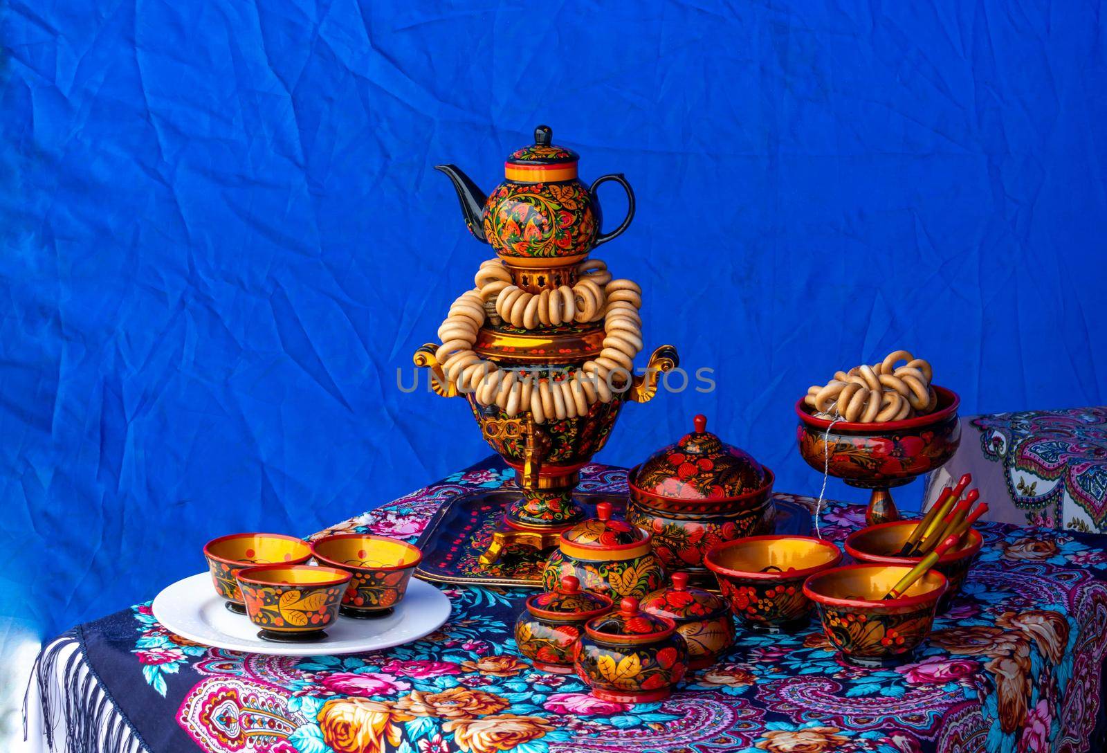 On the table on a colorful tablecloth is a traditional Russian samovar. Russian national tea ceremony.