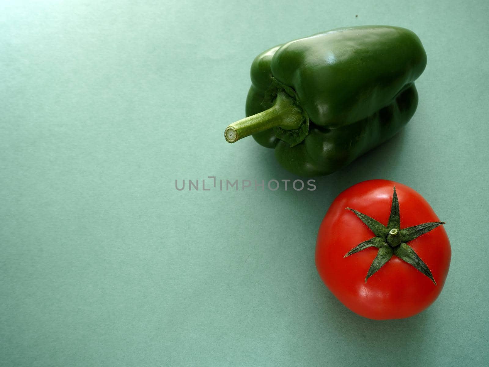 Ripe vegetables. Red tomato and green bell pepper, close-up, isolated. High quality photo