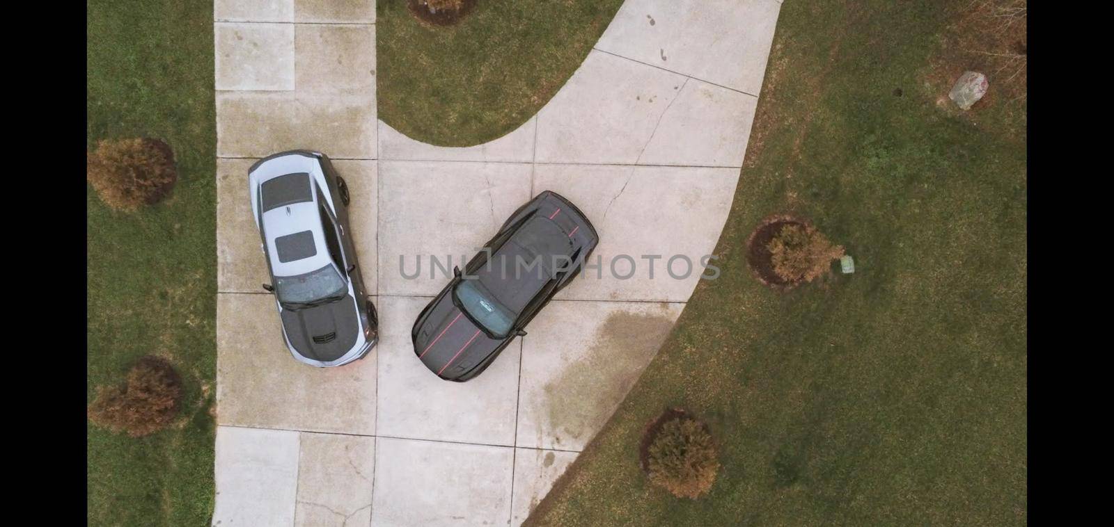 two cars parked in private driveway by digidreamgrafix