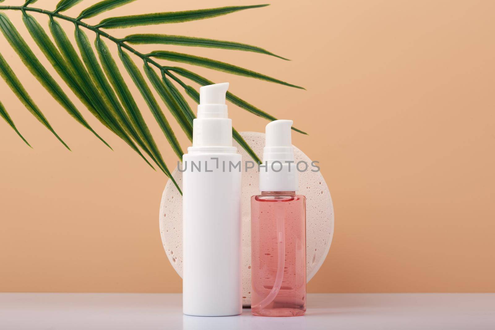 Skin care cream and cleansing foam against beige background with palm leaf. Beauty products for woman by Senorina_Irina