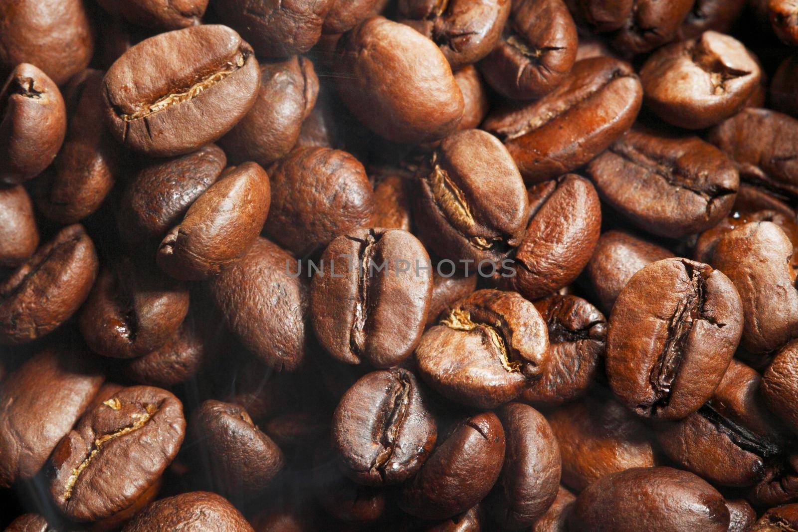 Hot roasted coffee beans clo se up detail background