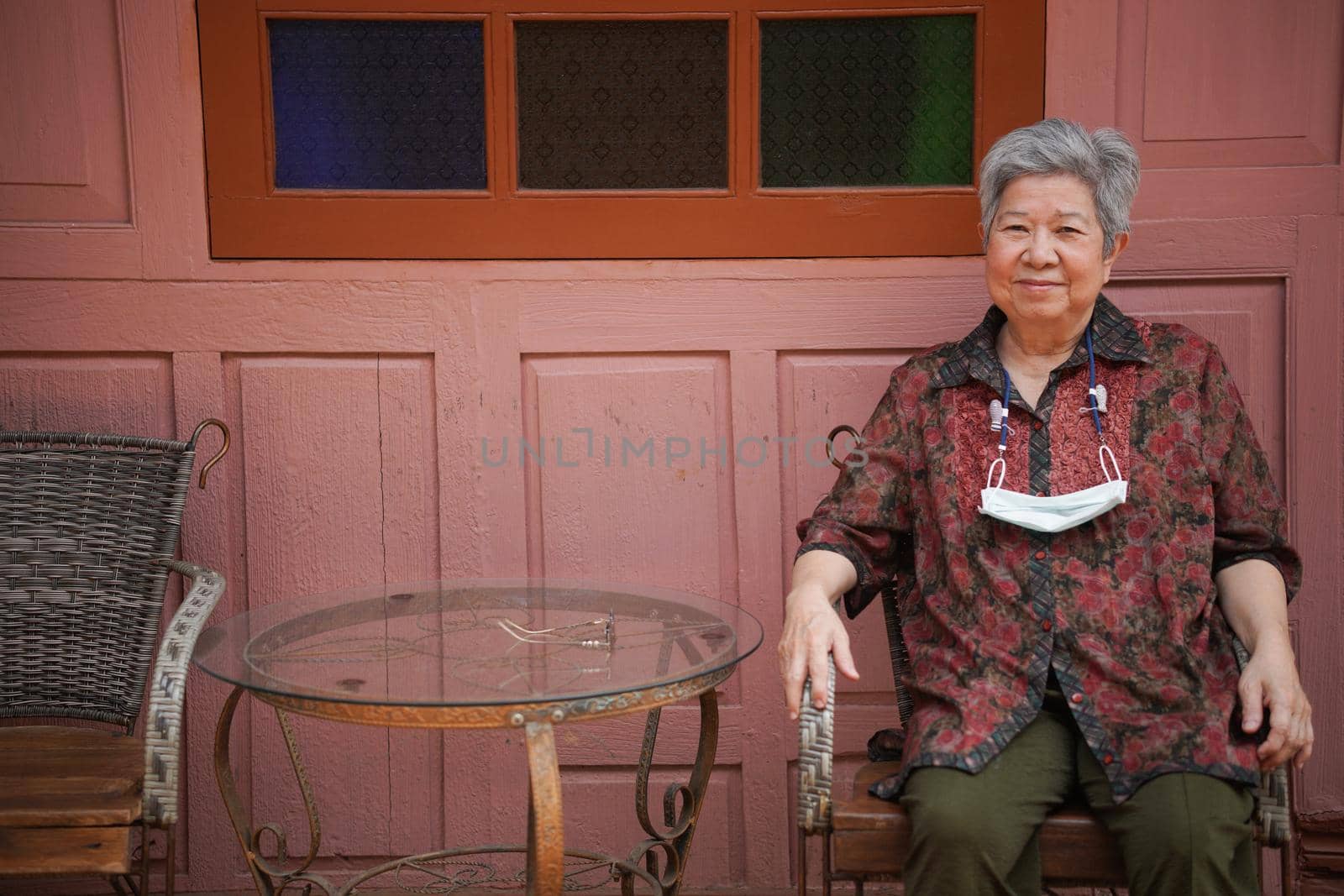 asian old elder woman elderly female relaxing resting on balcony terrace. senior leisure lifestyle