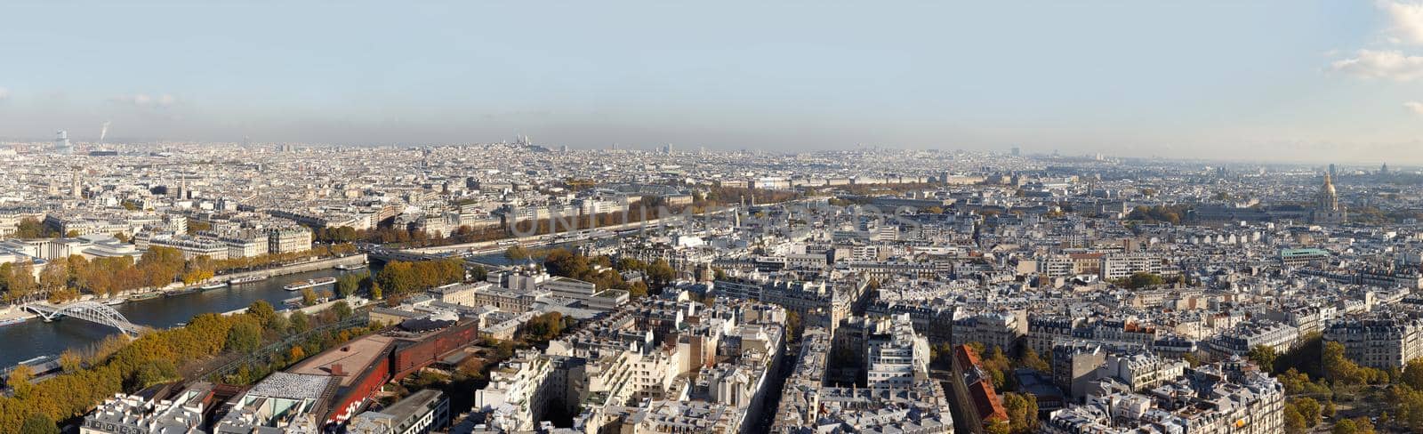 Cityscape of Paris City. Aerial panoramic view of Paris roofs and Seine river as seen from Eiffel Tower in autumn time