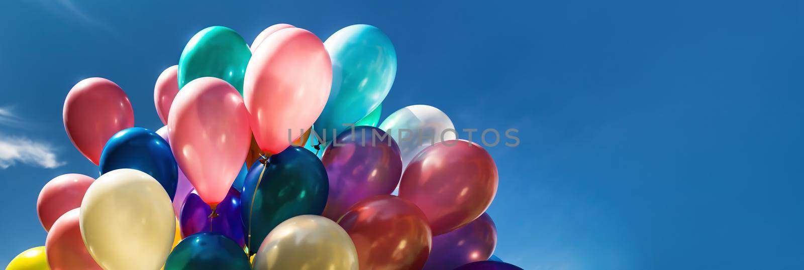 Multi-colored balloons on blue sky background by palinchak