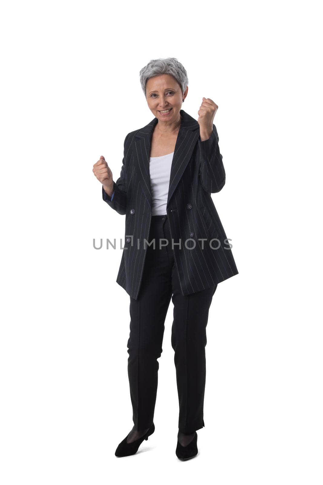 Full length portrait of happy beautiful mature asian woman holding fists isolated on white background, business people