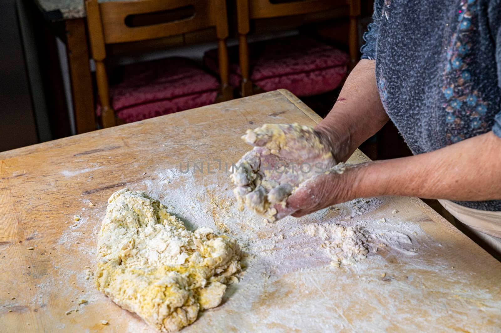 grandmother preparing homemade dough dough with flour and eggs