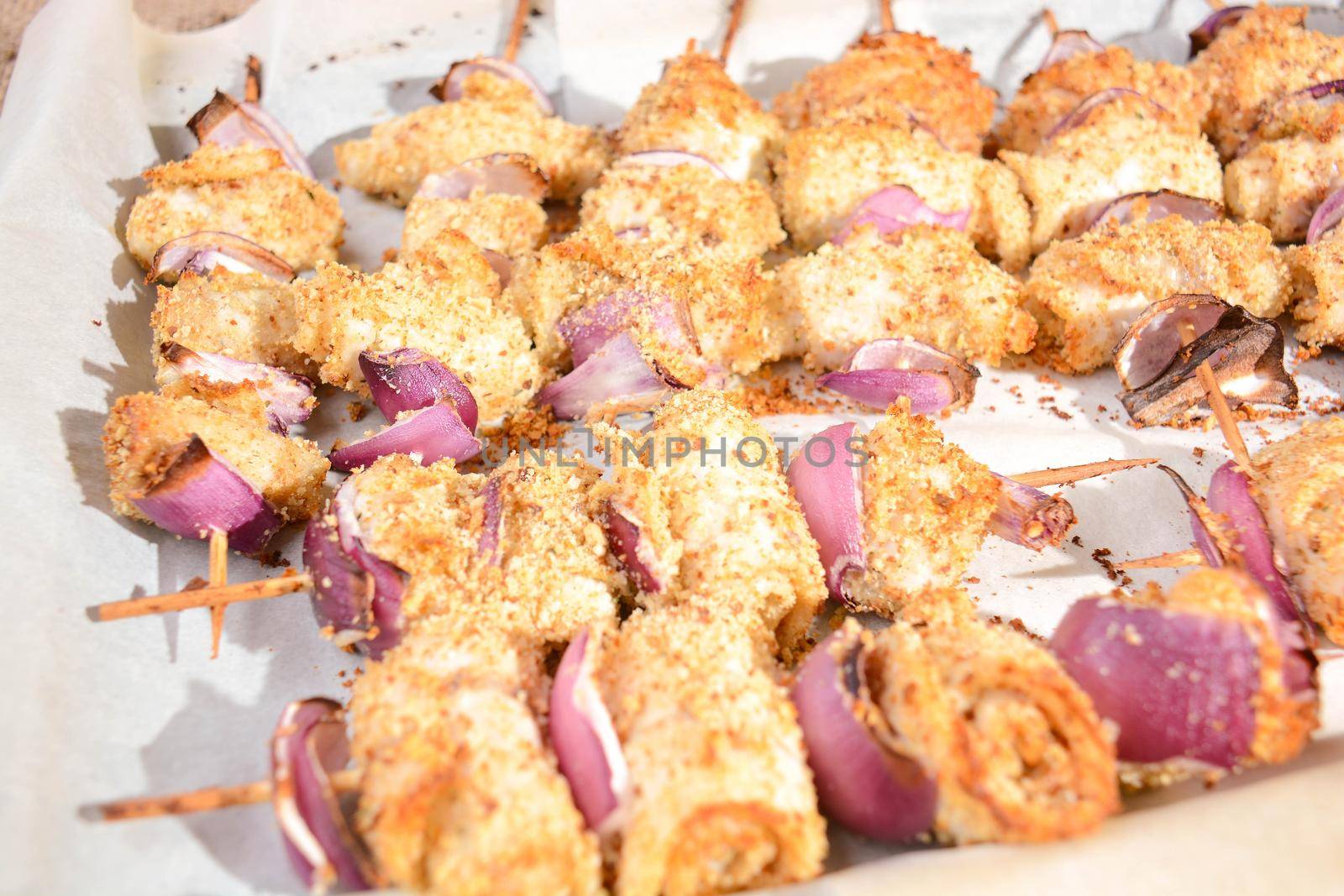 finger food skewers of fish and onion au gratin baked with chopped bread