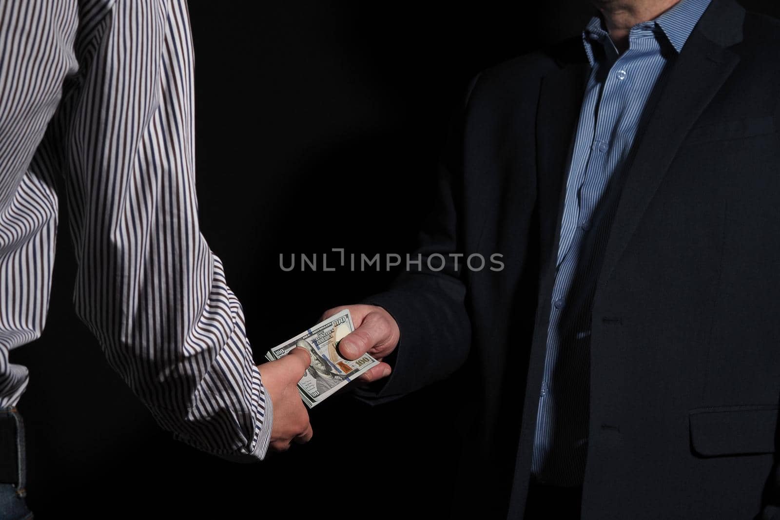 Business and finance. People hand over cash to the American dollar from hand to hand. High quality photo