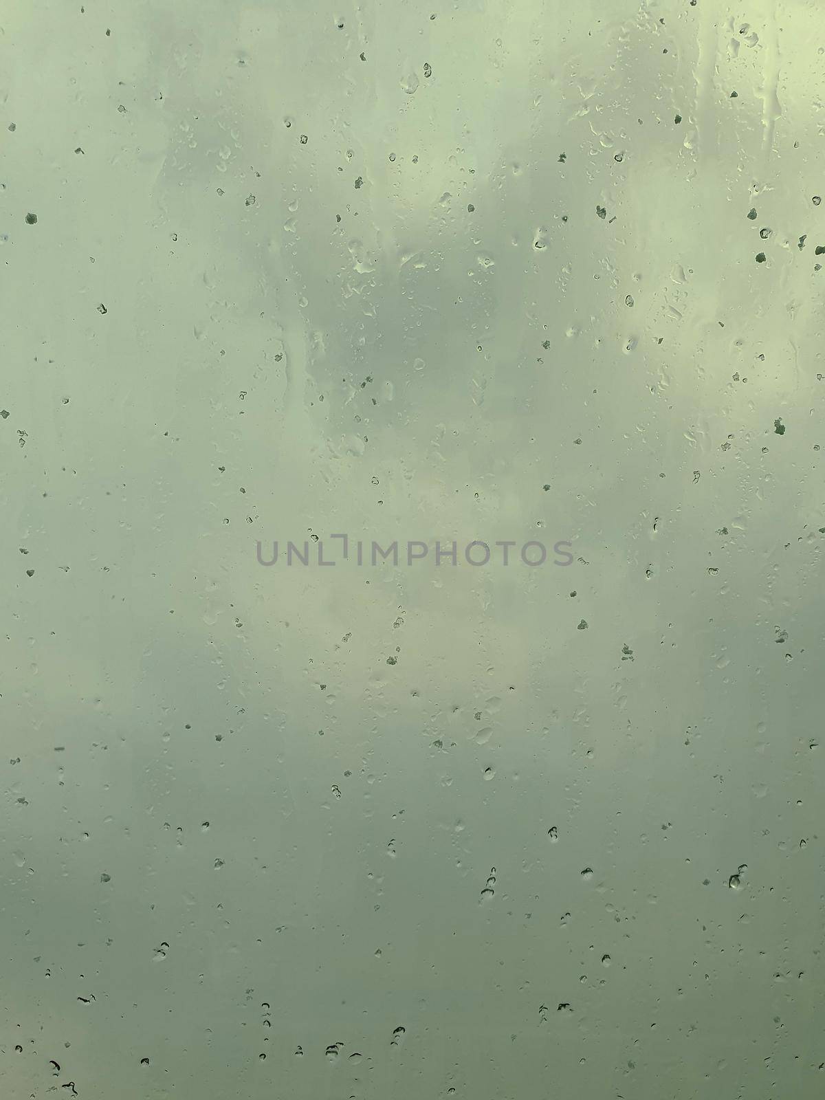 View through wet window of stormy weather by hamik