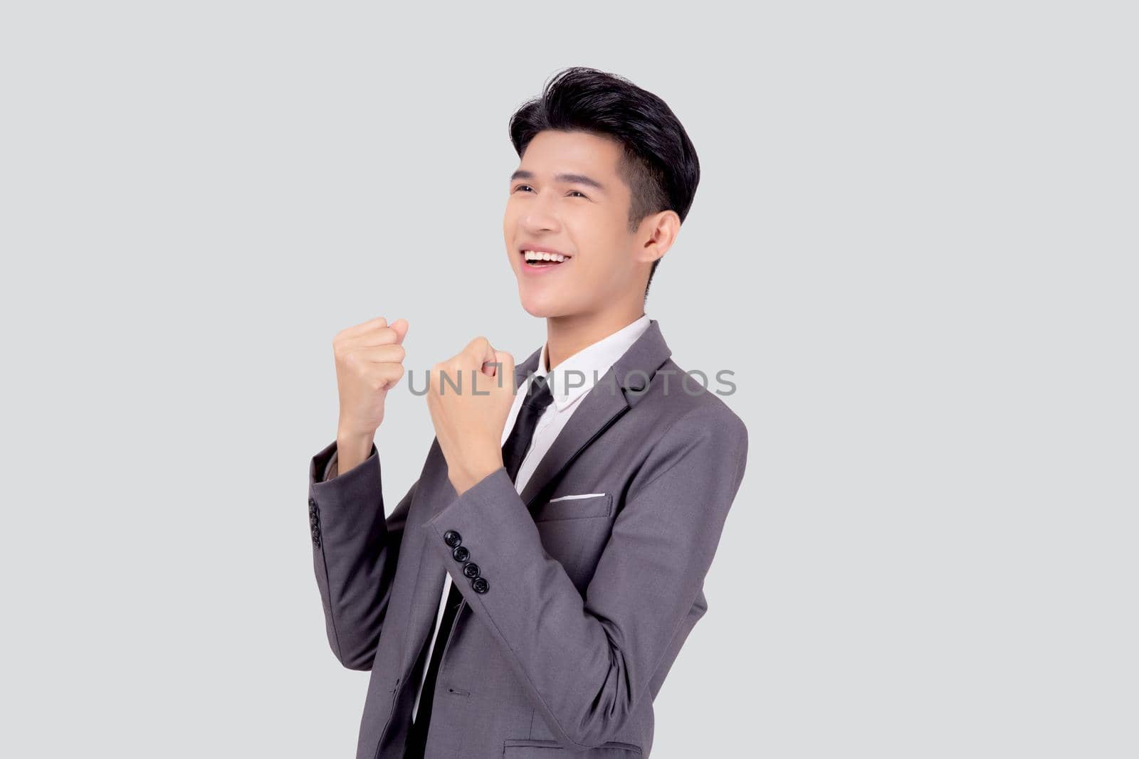 Portrait businessman in suit standing with win success isolated on white background, young asian business man is manager or executive having confident and excited is positive, expression and emotion.