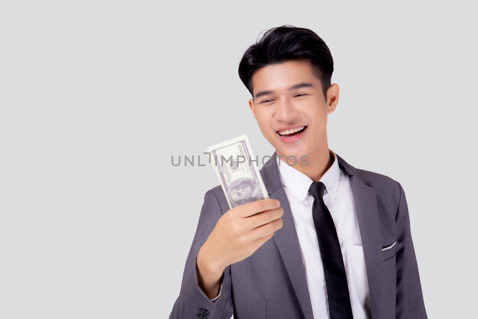 Young asian business man holding money dollar isolated on white background, businessman in suit holding banknote and success and excited with finance, savings and investment, income and spending.