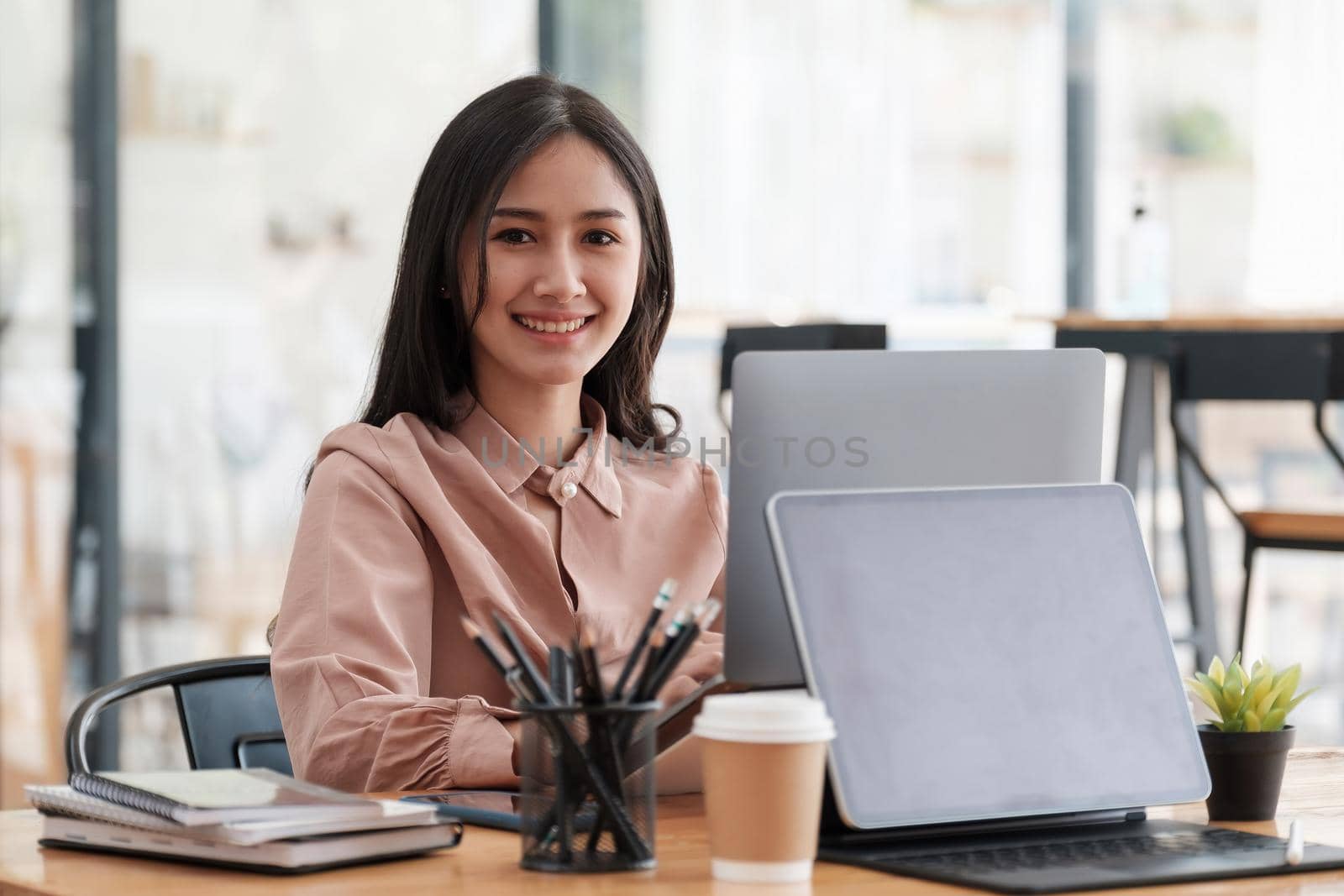 Portrait of young asian businesswoman beautiful charming smiling look at camera in the office