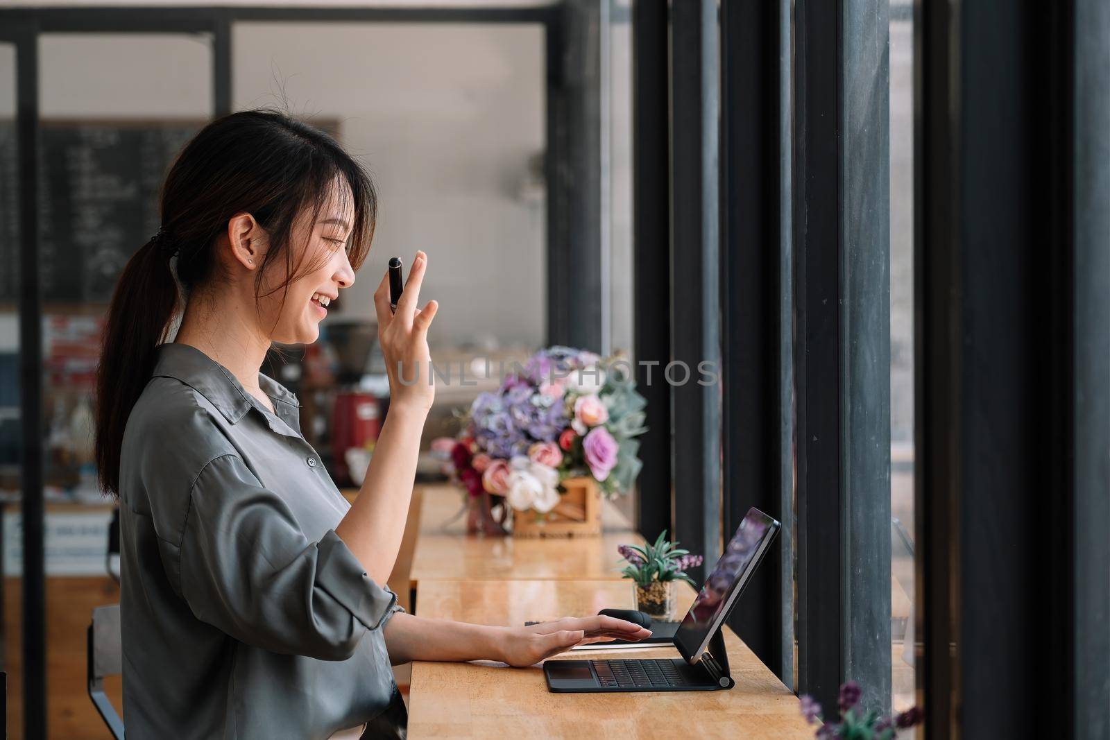 Video call communication lead asian leader talk to colleagues work from home office wear headphones at virtual meeting. Student use laptop and internet e-learning remotely by nateemee