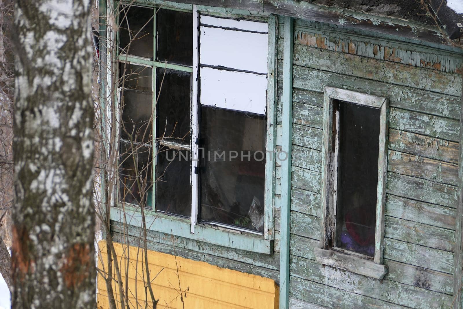 Abandoned wooden house. An old house in a village with no windows. High quality photo