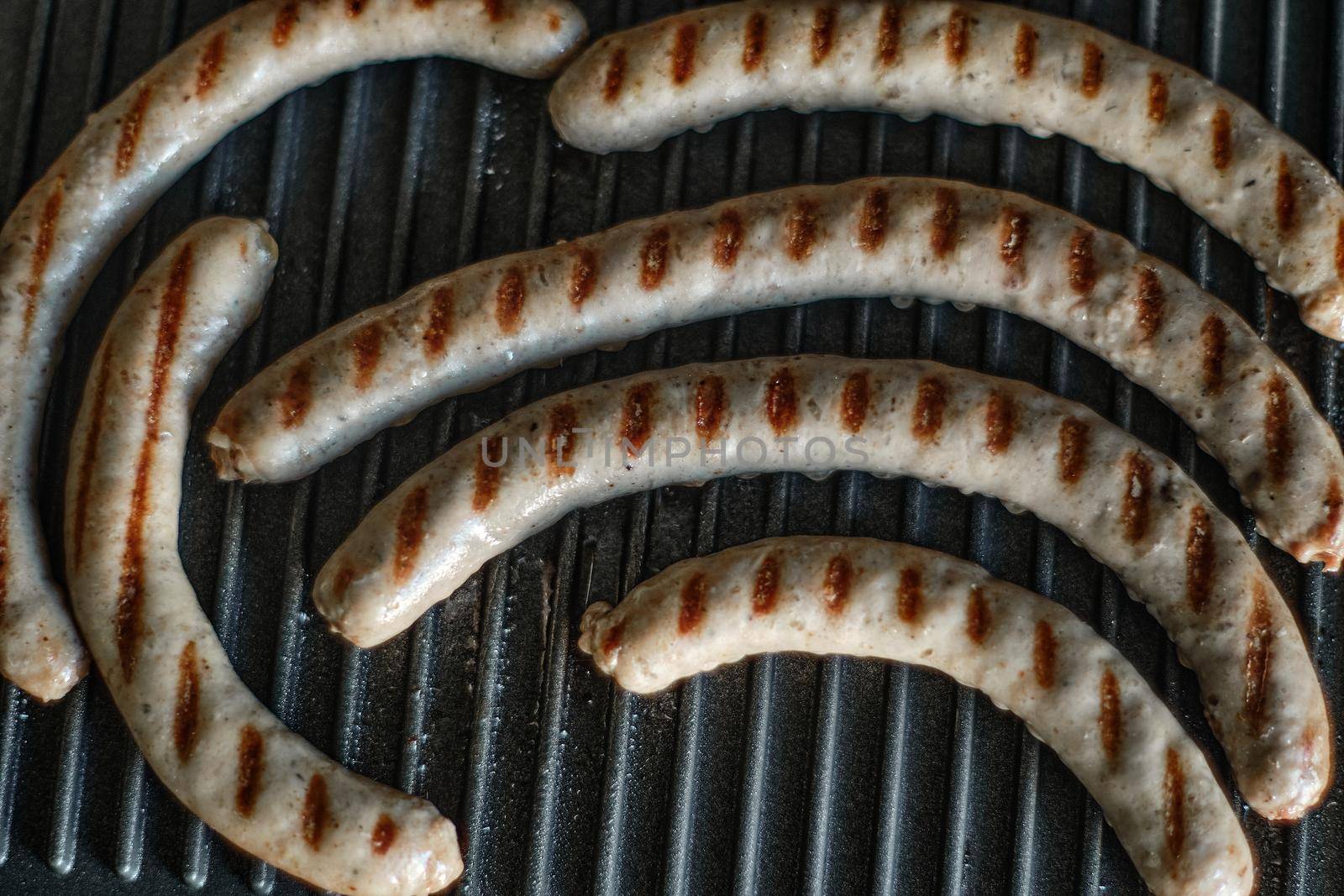 Grilled sausages are cooked, close up shot