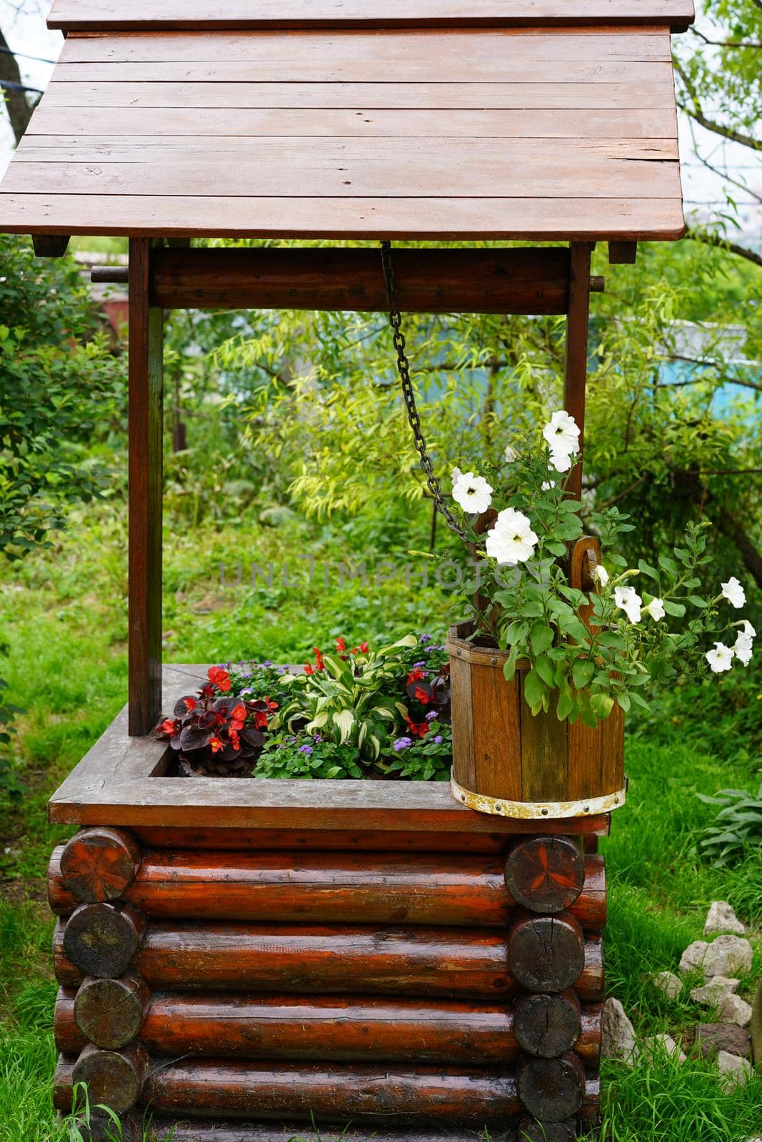 Rural landscape with flowers in a wooden bucket.