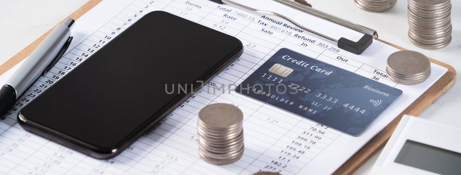 Design concept of annual summary analysis review report with calculator, paying with electronic device and credit card.